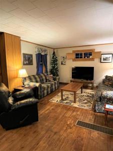 ein Wohnzimmer mit einem Sofa, einem Tisch und einem TV in der Unterkunft The Cary Mine House in Hurley