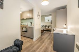 an open living room with a kitchen and a living room at Relaxing & Cozy Studio Apartment - Oasis in the Heart of Edinburgh - Sleeps Up to 3 Guests in Edinburgh