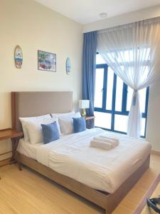 a bedroom with a large bed with a window at MrK Penthouse at Timurbay in Kuantan