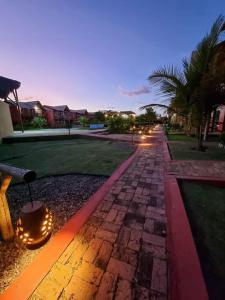 a cobblestone street with a lantern on it at night at Chaleville Coqueiro 1001 in Luis Correia