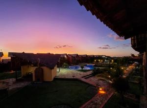 a view of a resort with a sunset in the background at Chaleville Coqueiro 1001 in Luis Correia