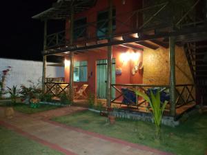 a house with a light on the side of it at Chaleville Coqueiro 1001 in Luis Correia