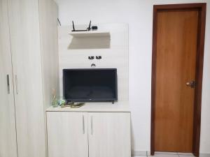 a tv sitting on top of a cabinet in a room at Chaleville Coqueiro 1001 in Luis Correia