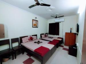 a bedroom with a bed and a flat screen tv at Satkar Hotel in Jaipur