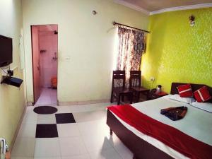 a bedroom with a large bed and a bathroom at Satkar Hotel in Jaipur