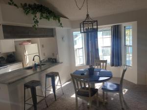 a kitchen with a table and chairs and a dining room at Somerset Villas 84 in Kissimmee