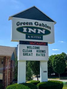 a sign for a green cabbage inn and suites at Green Gables Inn in Branson