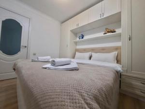 a bedroom with a large bed with towels on it at Квартира на Тулебаева in Almaty +2 photos
