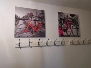 two paintings of bikes hanging on a wall at Maidstone Heights II in Maidstone