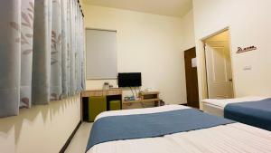 八八小屋心享民宿客房内的一张或多张床位