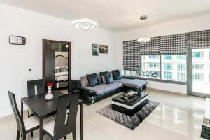 a living room with a couch and a table at 1BR Boulevard View 29 Blvd T2 Downtown in Dubai