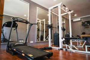 a gym with two treadmills and a treadmill and mirrors at Coconut Lodge Resort in Jepara