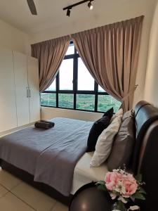 a bedroom with a large bed with a large window at Conezion Residence Putrajaya nearby IOI City Mall in Putrajaya