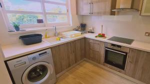 a kitchen with a washing machine and a sink at STAY Downtown Retreat in Limassol