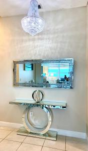 a bathroom with a mirror and a toilet at Castle Beach Resort Condo Penthouse or 1BR Direct Ocean View -just remodeled- in Miami Beach