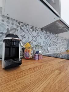 a coffee maker sitting on a counter in a kitchen at Aura Apartment - Ski In & Ski Out - Cerviniaholidays-com in Breuil-Cervinia