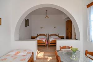 a living room with two beds and a table at Blue Bliss in Ambrami