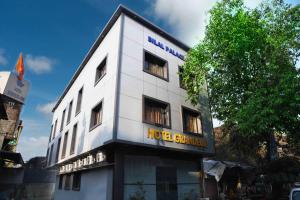 a white building with a hotel sign on it at Hotel Grandeur-Near Mumbai International Airport in Mumbai