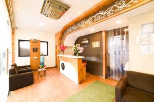 a waiting room with two chairs and a reception desk at Hotel Grandeur-Near Mumbai International Airport in Mumbai +48 photos