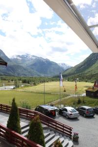 a view of cars parked in a parking lot with mountains at Jostedal Hotel in Jostedal
