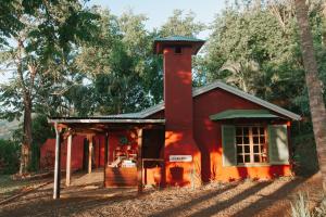 a red house with a chimney on top of it at La Vieille Cheminee in Chamarel