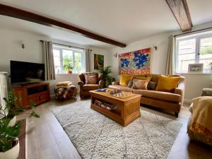 a living room with a couch and a coffee table at Kings Cottage - Heart of the Deverills in Warminster