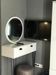 a white dressing table with a mirror and a tv at Utarit Hotel in Istanbul