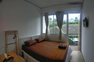 Un pat sau paturi într-o cameră la Rion Hostel Bogor