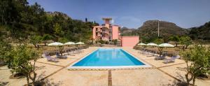a resort with a swimming pool with chairs and umbrellas at Residence Villa Mare Taormina in Letojanni