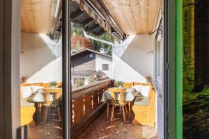 a balcony of a restaurant with tables and chairs at Ferienwohnung Waldruhe in Garmisch-Partenkirchen