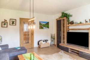 a living room with a large flat screen tv at Ferienwohnung Waldruhe in Garmisch-Partenkirchen