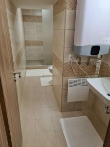 a bathroom with a toilet and a sink at City Center Apartmanház in Eger