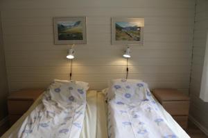 a room with two beds with blue flowers on them at Jostedal Hotel in Jostedal