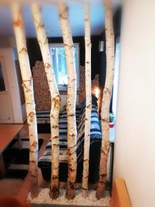 a bed made out of birch trees at APARTMA ROŽLE - ROGLA in Vitanje