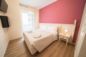 Postel nebo postele na pokoji v ubytování Hotel Orchidea