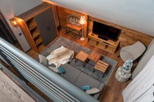 an overhead view of a living room with a dog laying on the floor at Chalet Everest - Luxury Apartments in Prato Nevoso