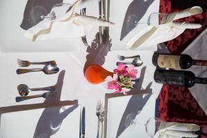 a table with glasses and a bottle of wine and a flower at Hotel Ristorante Milano in Bad Tölz