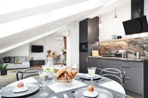 a kitchen and living room with a table and chairs at Szpitalna 9 Residence in Kraków