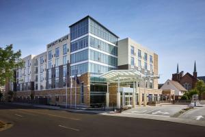 a large glass building on the corner of a street at Hyatt Place Evansville in Evansville