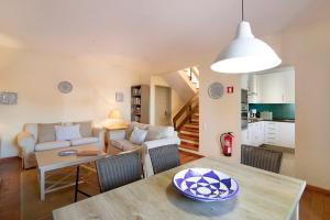 a living room with a table and a couch at Casa Allan in Vale do Lobo