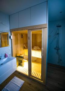 a bathroom with a shower with a glass door at Villa Nera - Etwa in Mostar