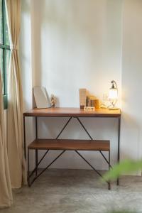 a wooden desk with a lamp on it next to a window at Big Tree Boutique Hotel in Ko Tao