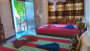 Voodi või voodid majutusasutuse Sigiriya River Side Resort toas