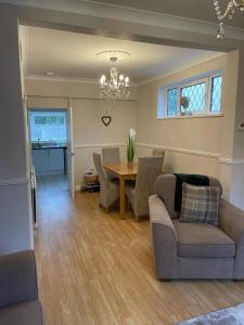 a living room with a table and chairs and a dining room at Silver Stag Properties,Comfy House in Coalville in Hugglescote