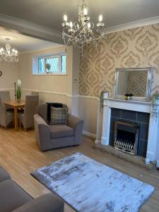 a living room with a couch and a fireplace at Silver Stag Properties,Comfy House in Coalville in Hugglescote