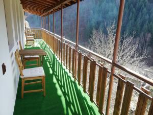 a balcony of a house with a table and chairs at GUEST HOUSE ELENA in Kosovo