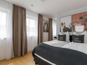 a bedroom with a large bed and a window at limehome Passau Bahnhofstraße in Passau