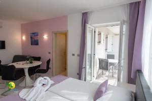 a hotel room with a bed and a table and a dining room at Villa Green Palm in Vrsar +104 photos