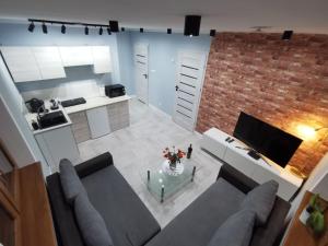 a living room with a couch and a table at Na Jedwabnej in Lubawka