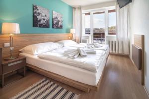 Posteľ alebo postele v izbe v ubytovaní Hotel Vyhlídka